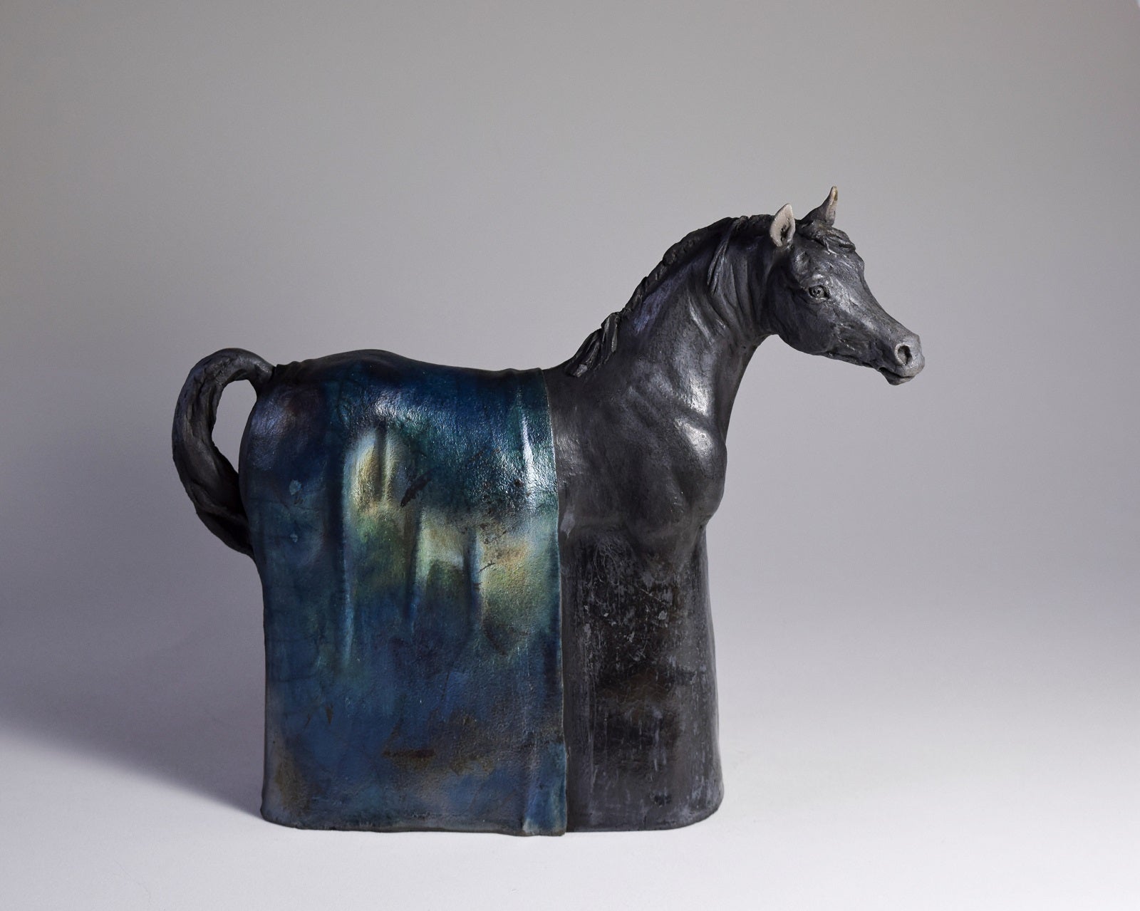 Black raku ceramic Arabian horse sculpture by Susie Benes