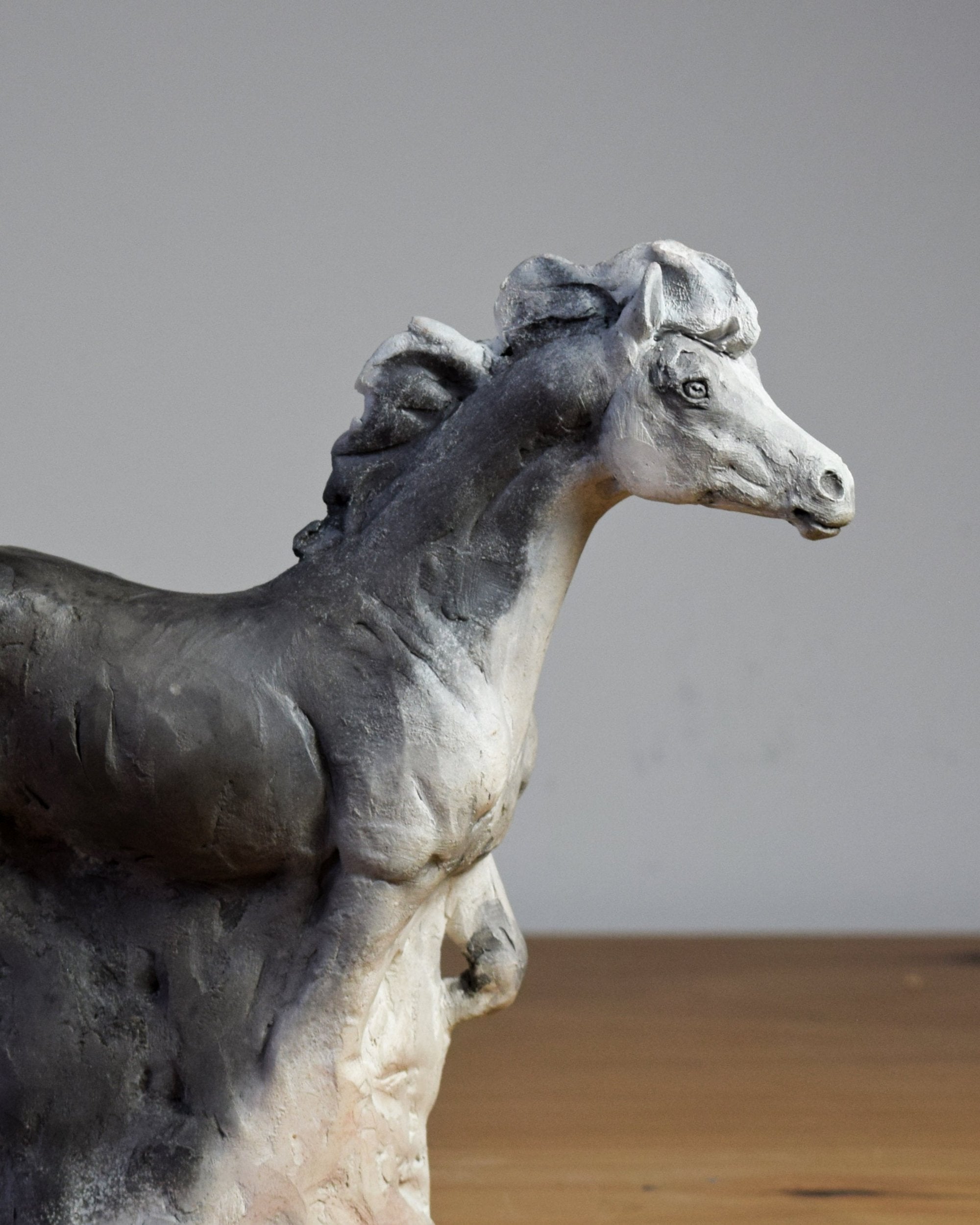 Smoke fired ceramic horse sculpture by Susie Benes