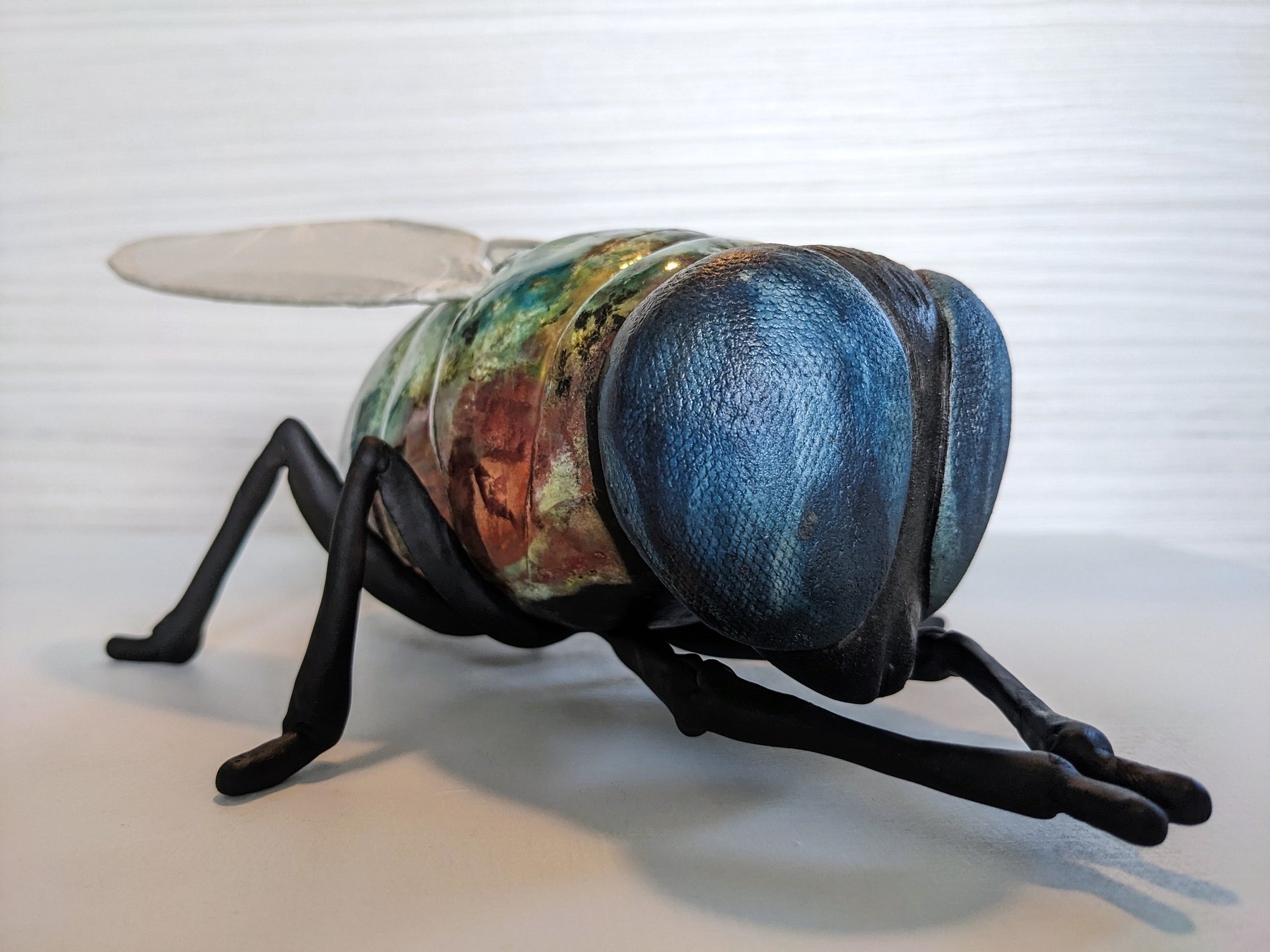 Giant fly wall sculpture from ceramic by Susie Benes