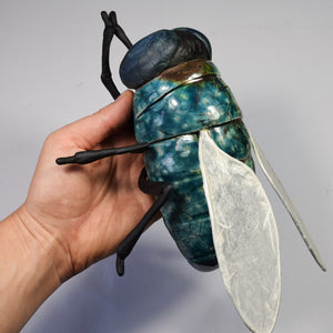 Giant fly sculpture made from ceramic by Susie Benes