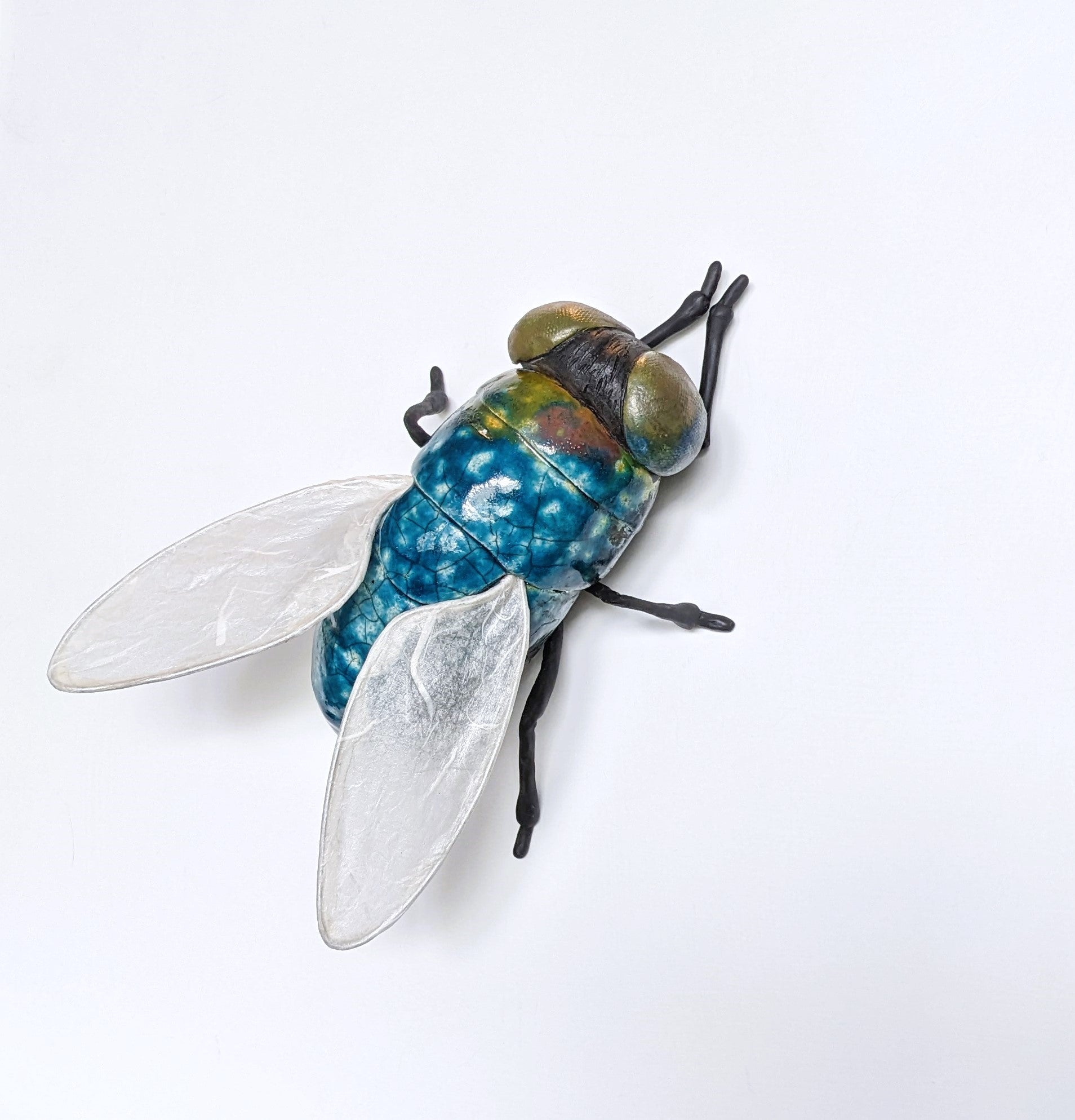 Giant fly wall sculpture from ceramic by Susie Benes