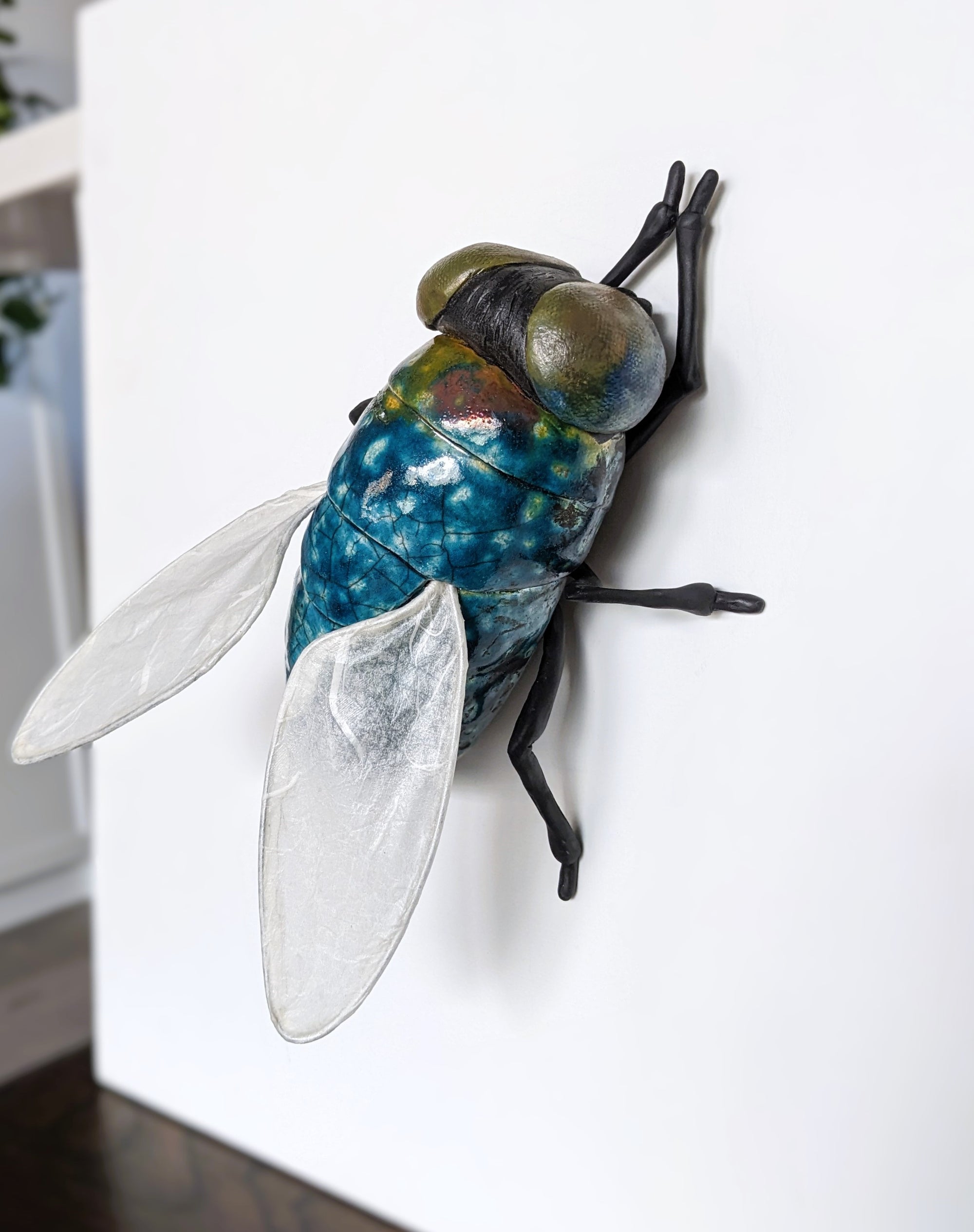 Giant fly wall sculpture from ceramic by Susie Benes