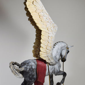 Pegasus with wings raised and gold bridle sculpture