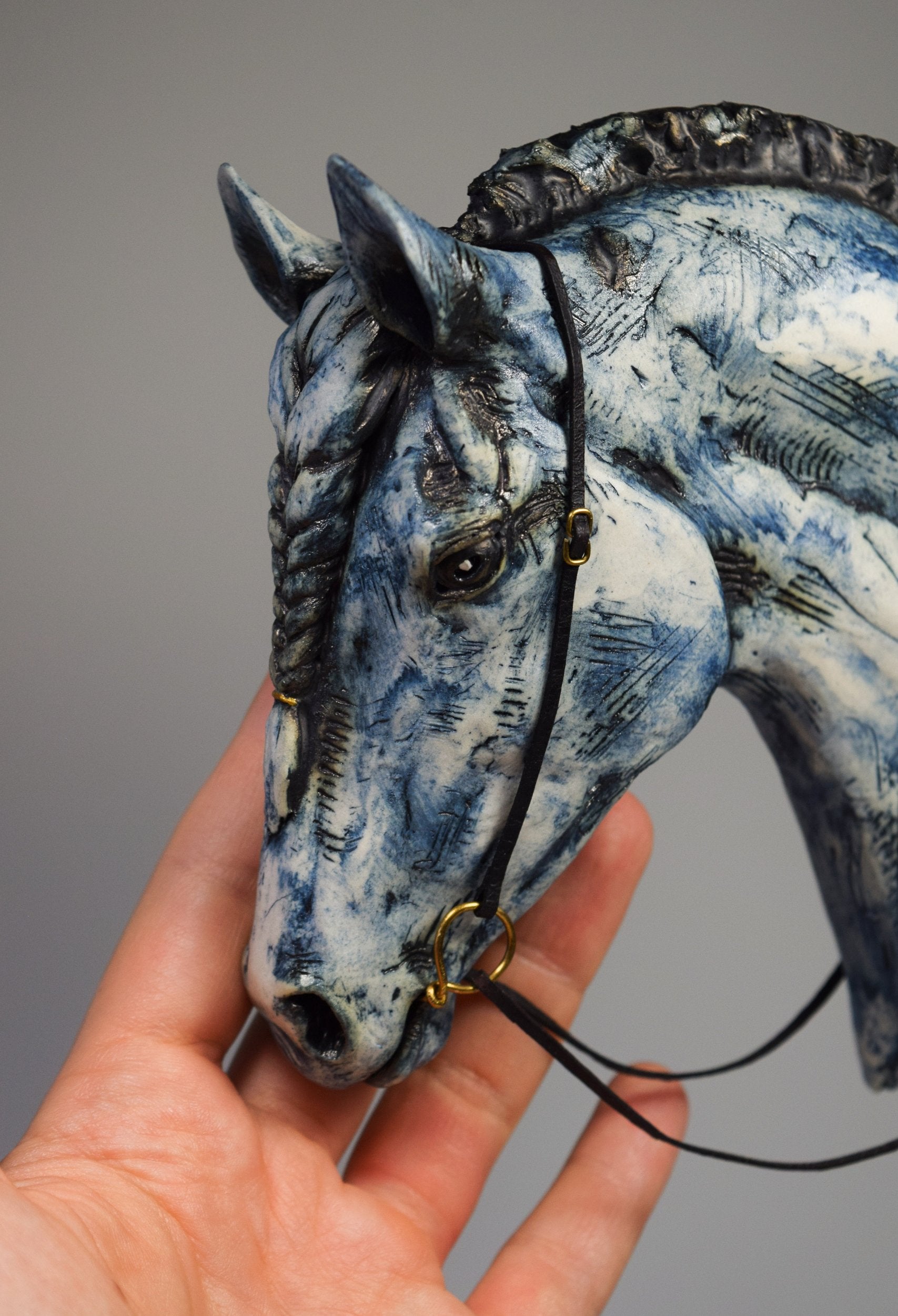 Blue ceramic horse head with braid sculpture by Susie Benes