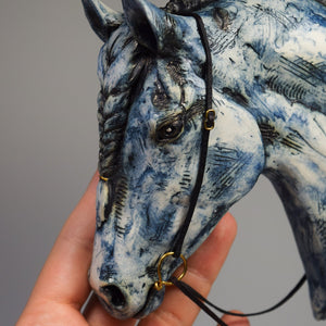 Blue ceramic horse head with braid sculpture by Susie Benes