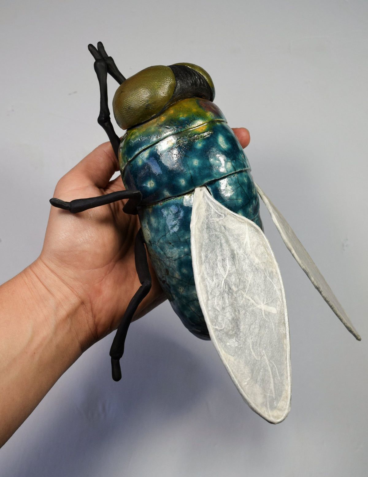 Giant ceramic fly wall sculpture by Susie Benes