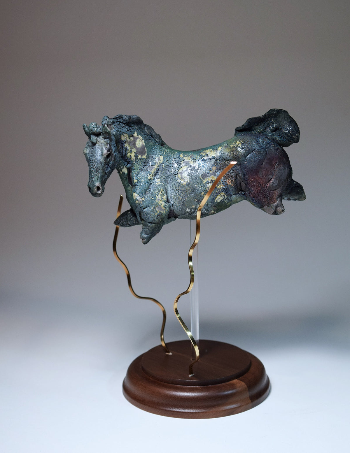 Blue aquatic horse in ceramic raku fired with brass kelp