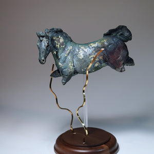 Blue aquatic horse in ceramic raku fired with brass kelp