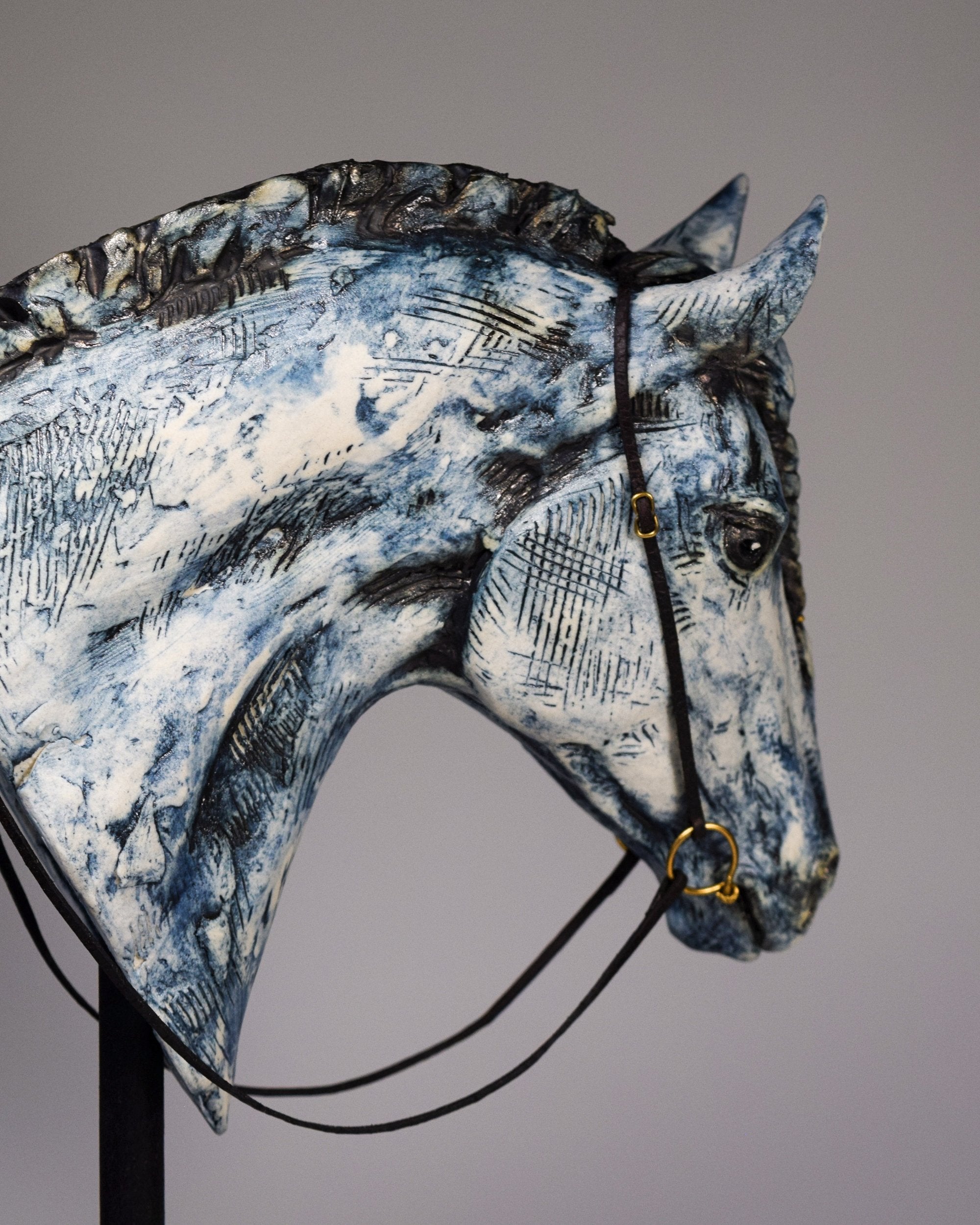 Blue ceramic horse head with braid sculpture by Susie Benes