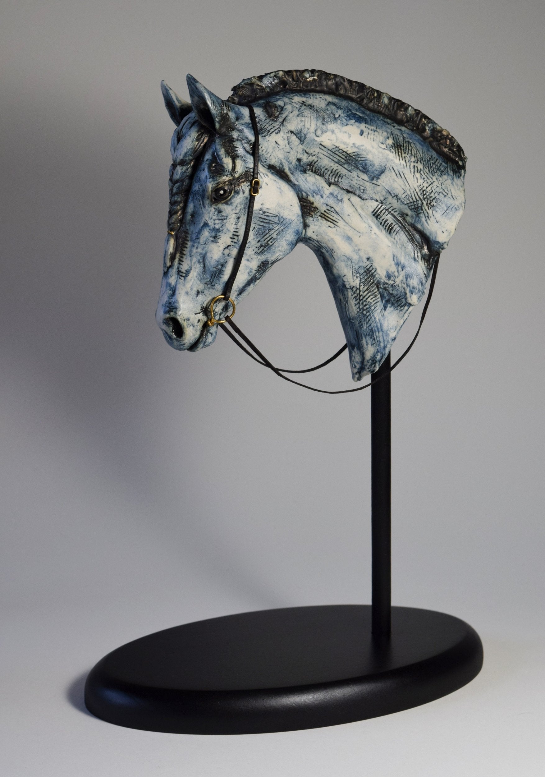 Blue ceramic horse head with braid sculpture by Susie Benes