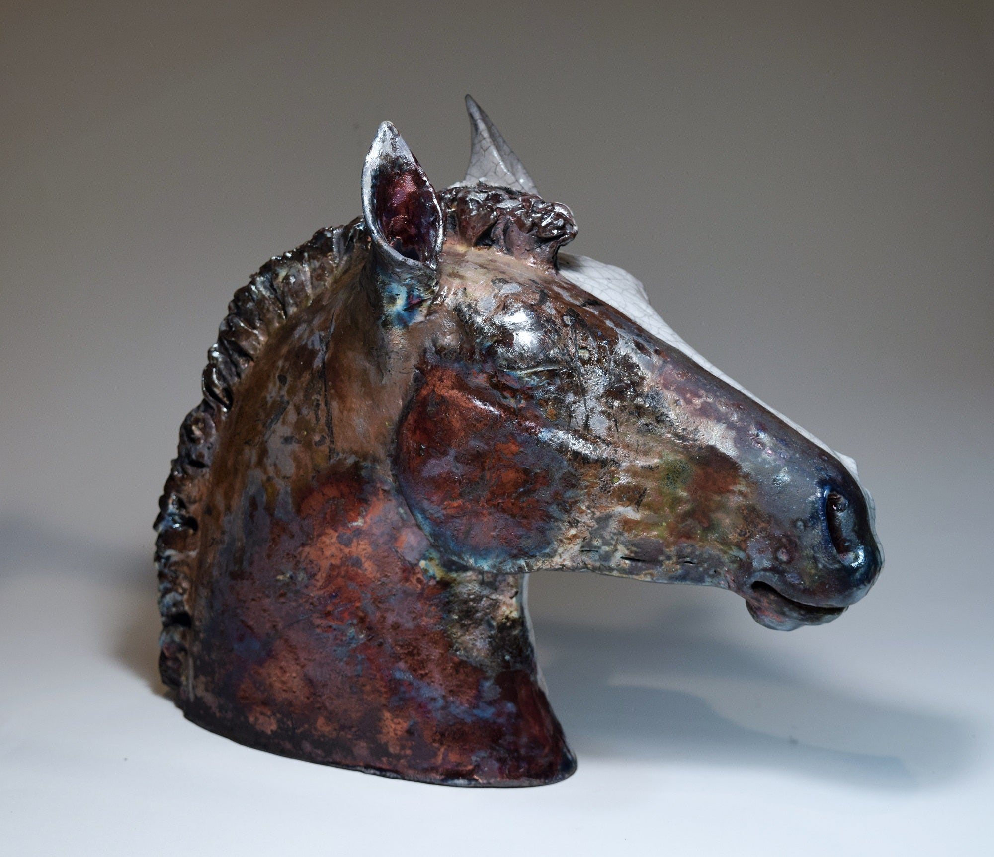 Raku ceramic horse head in black and white by Susie Benes