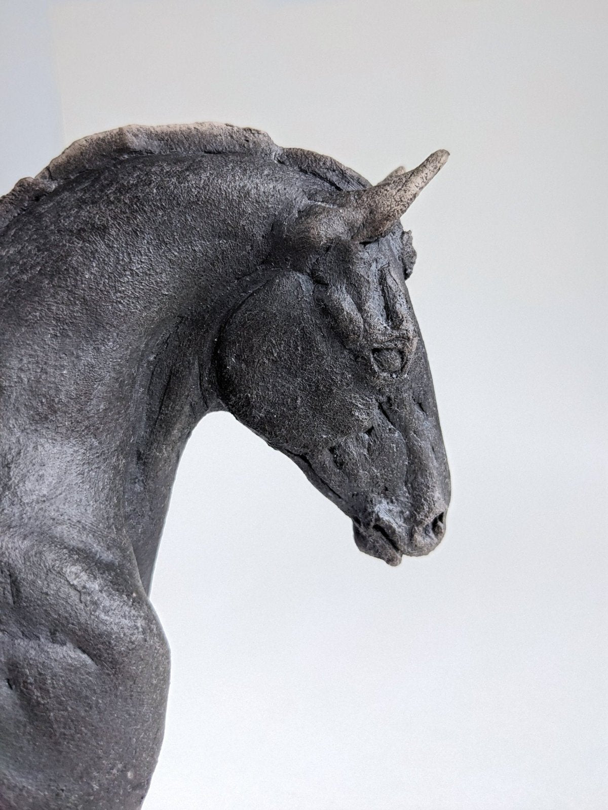 Close up on black ceramic horse head sculpture