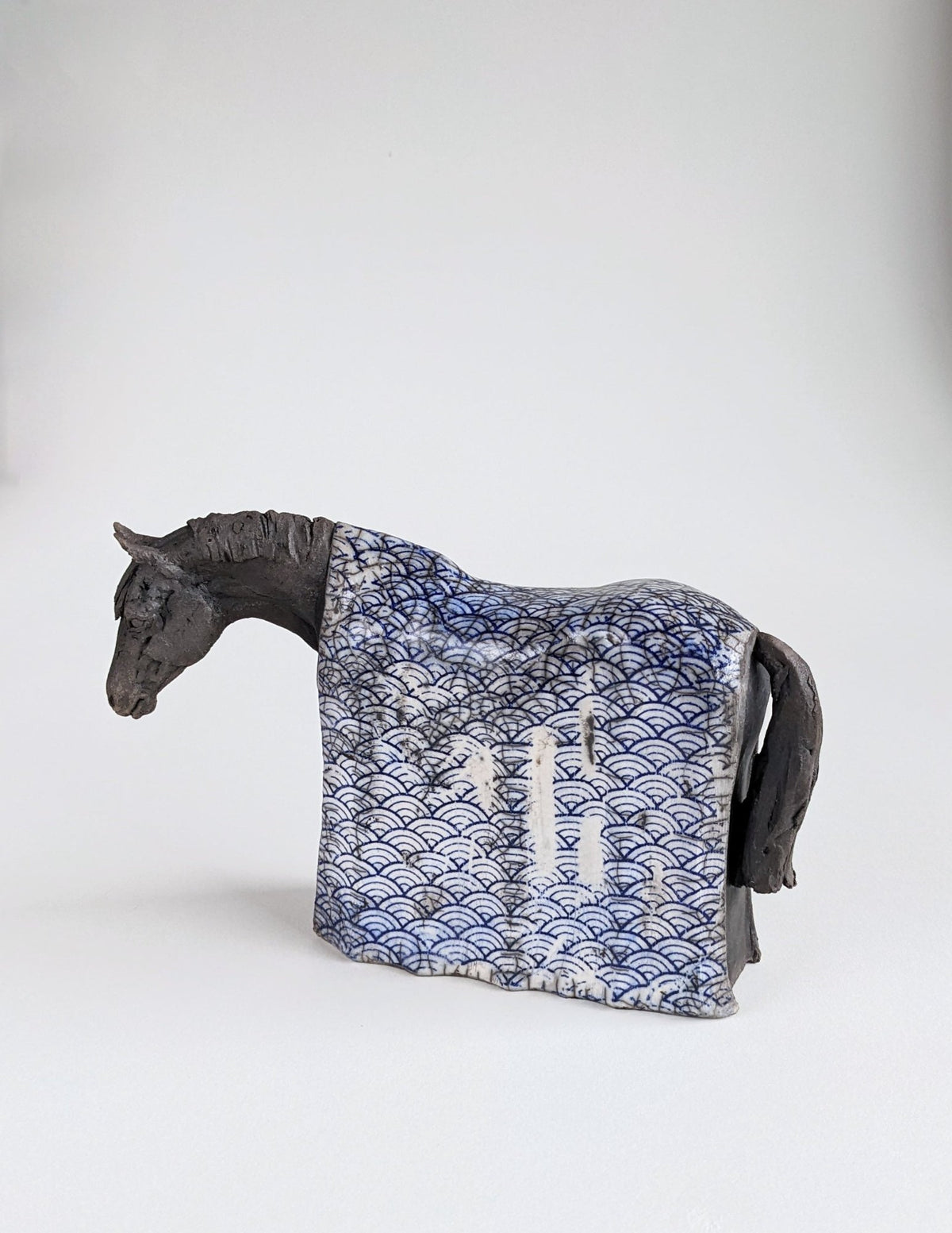 Black horse sculpture with Japanese blue design