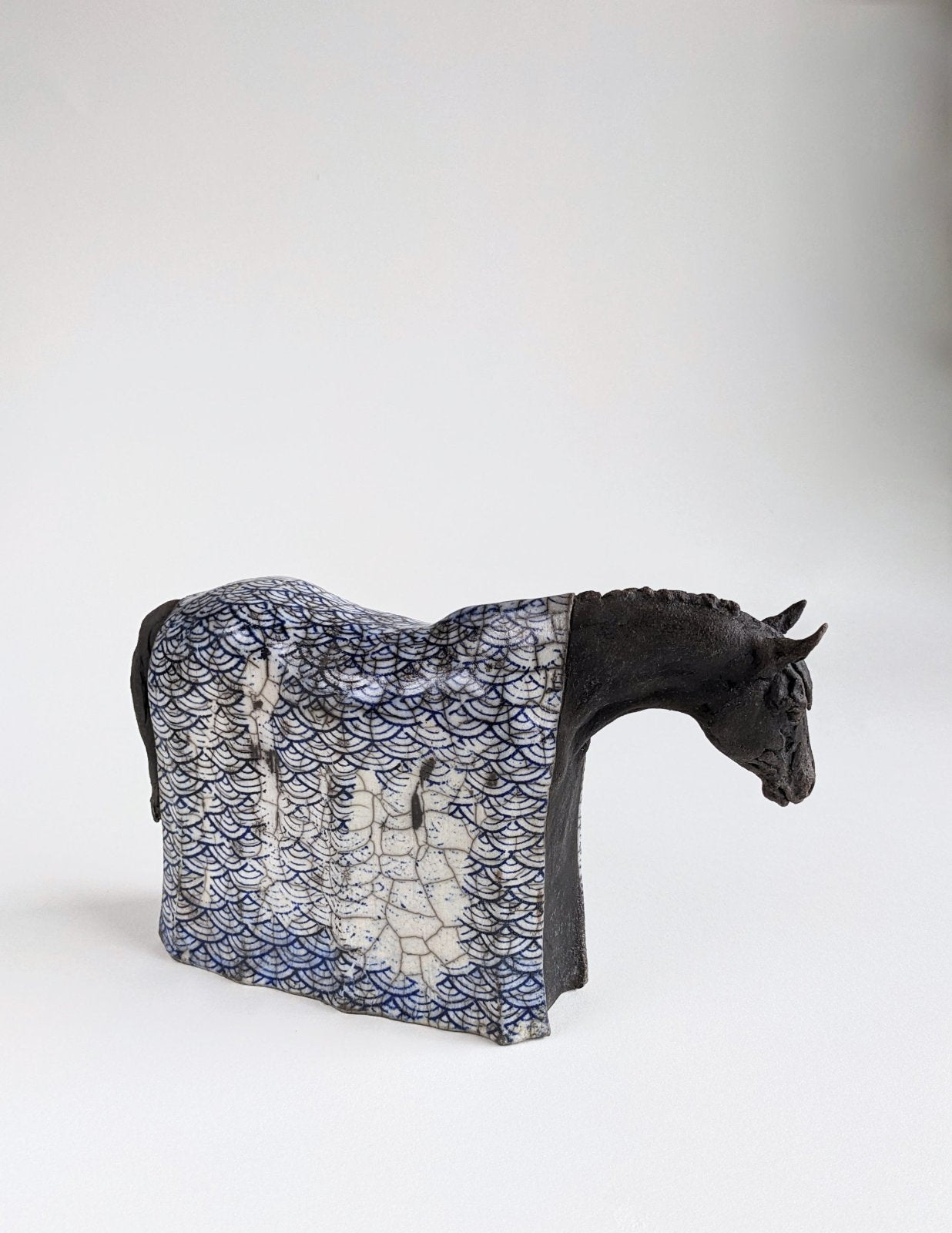 Black horse sculpture with Japanese blue design