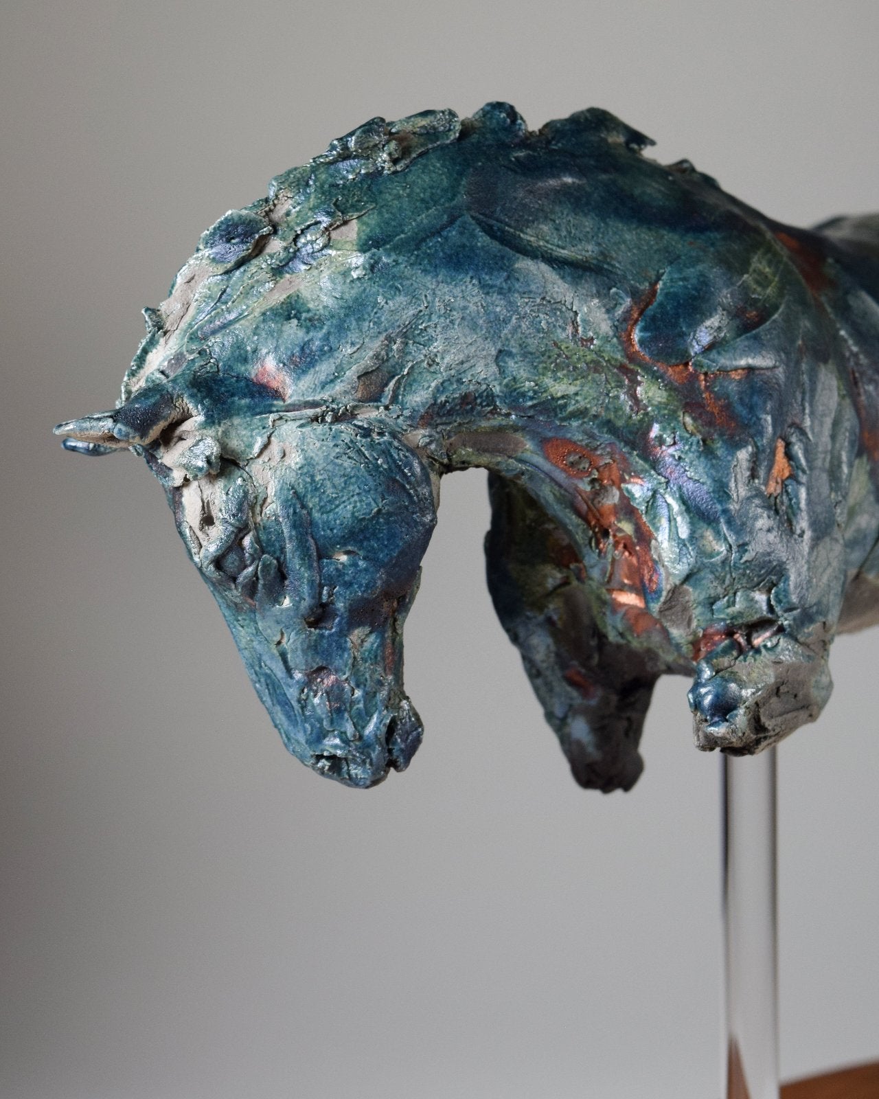 Close up blue and copper ceramic horse sculpture