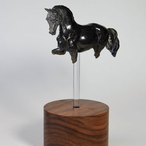 Black ceramic horse sculpture on tall wood base