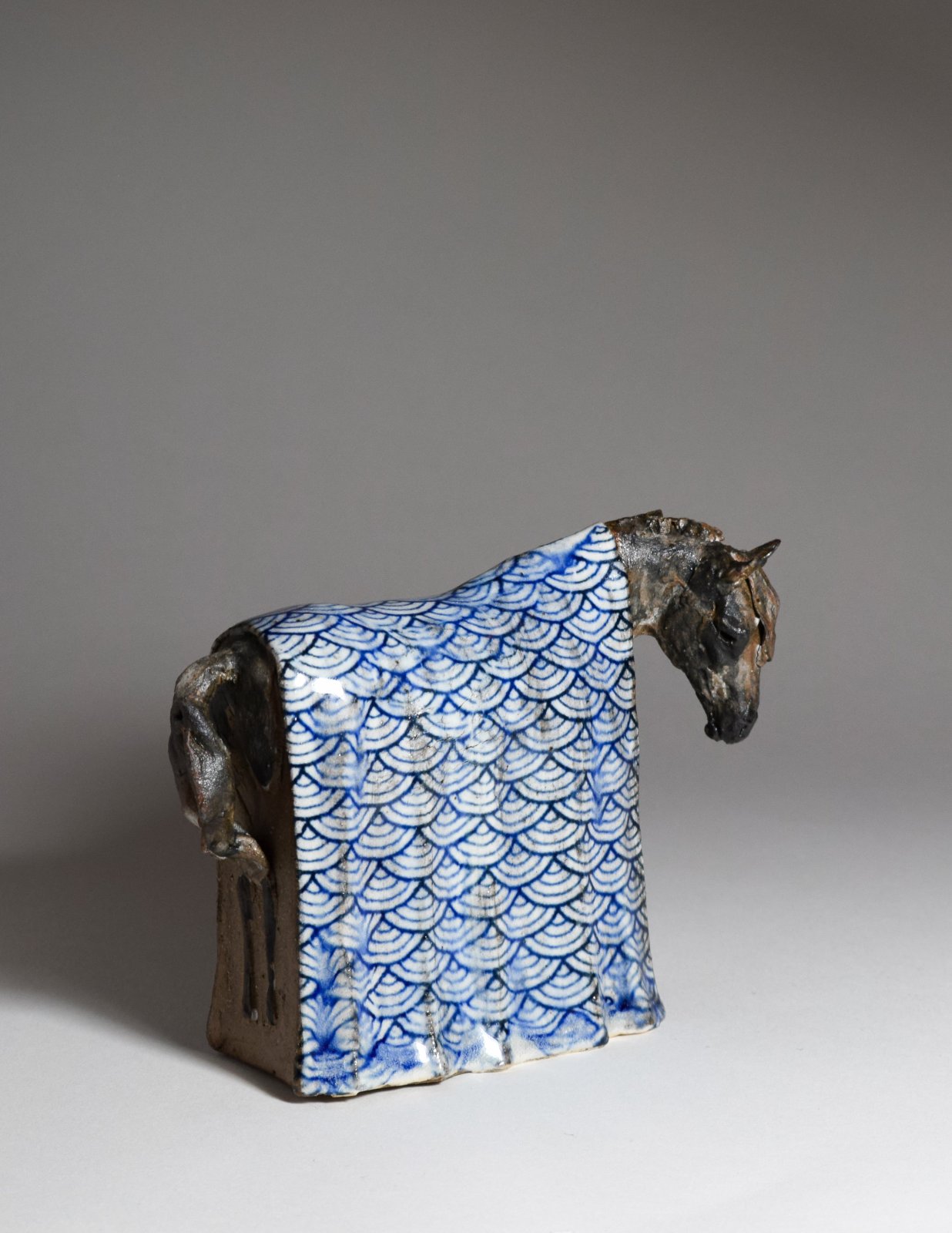 Small ceramic horse sculpture with Japanese pattern blanket